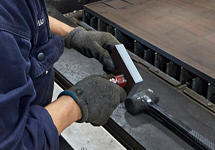 Amber steel worker handling metal material with safety gloves 